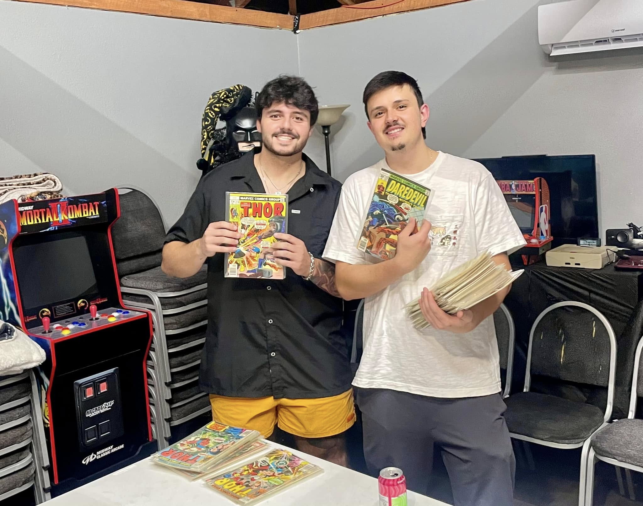 Two collectors holding comic books at the 50Dome